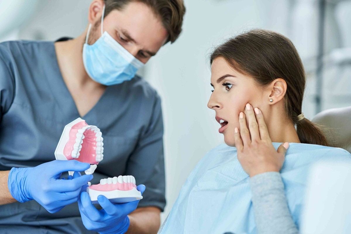 Dentist explaining dental implant options to a patient with missing teeth
